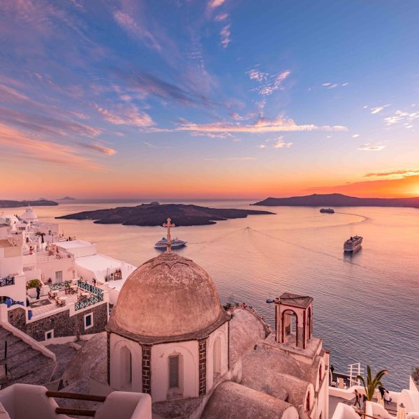 Amazing evening view of Santorini island. Picturesque spring sunset on the famous Fira village, Greece, Europe. Traveling concept background. Artistic inspirational sunset landscape, dream vacation